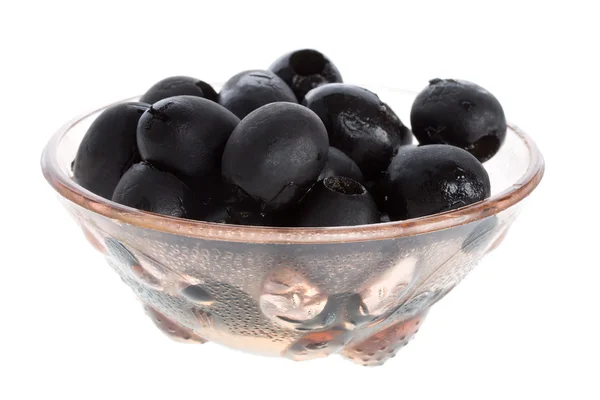Černé olivy na desce — Stock fotografie