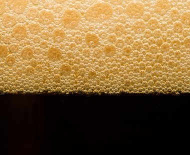 Foam from dark beer with bubbles clipart
