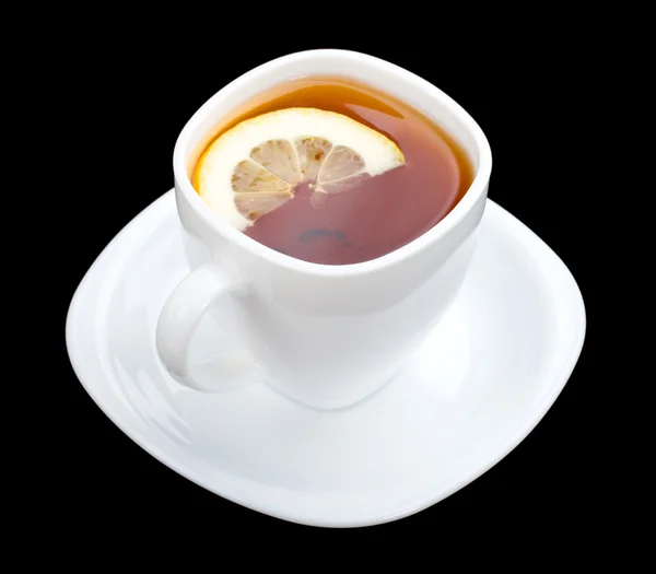 Šálek čaje s citronem a talířek na černém pozadí — 图库照片