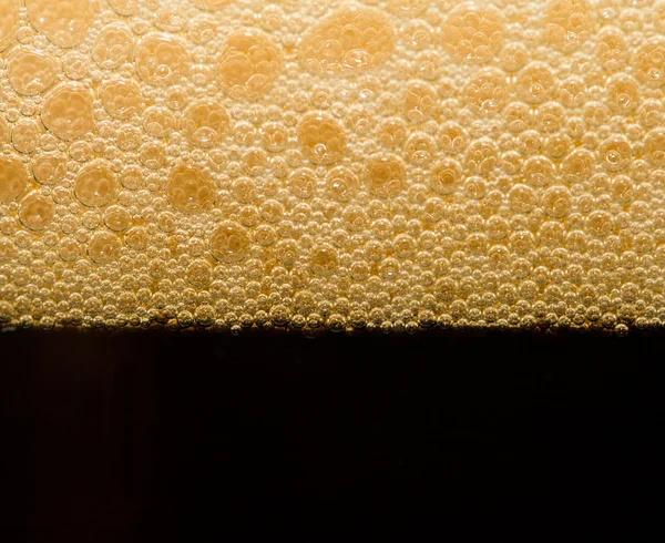 Foam from dark beer with bubbles — Stock Photo, Image