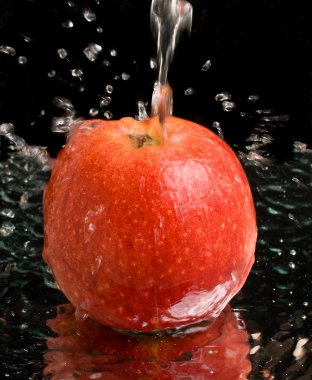 Red apple under water stream clipart