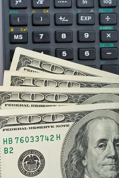Many us dollars over calculator — Stock Photo, Image