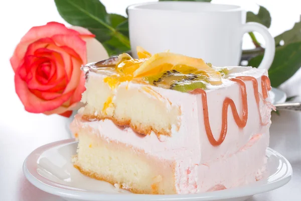 Piece of cake with fruits rose and cup — Stock Photo, Image