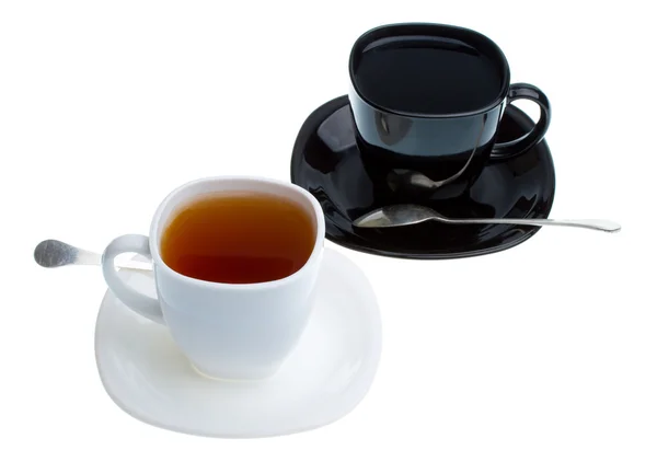 White and black cups with tea — Stock Photo, Image