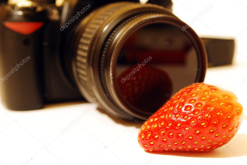 Strawberry and a photo camera