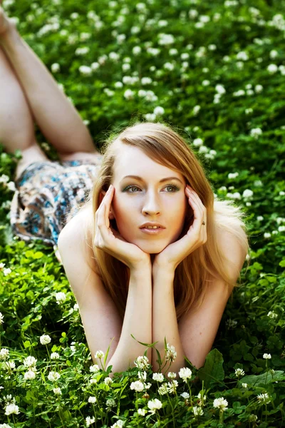 stock image Woman laying on the grass