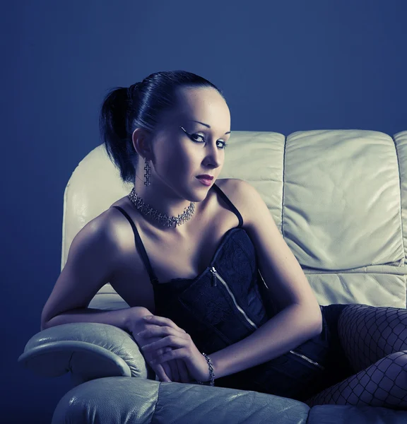 Portrait of sexy young model on sofa — Stock Photo, Image