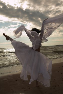 Woman dancing on the beach clipart