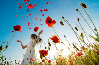 Girl relaxing  in poppy field clipart