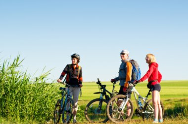 Cyclists relax biking outdoors clipart