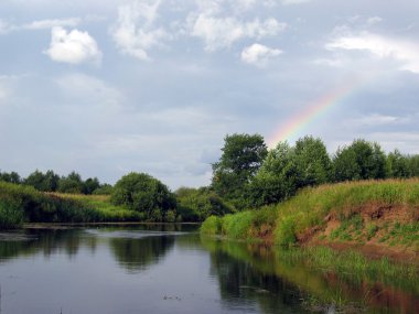 Rainbow over the river. clipart