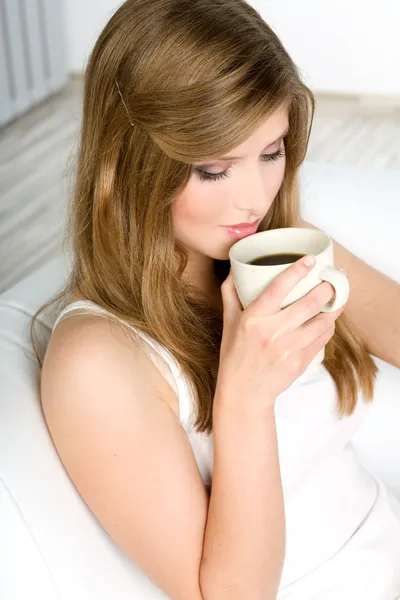 Όμορφη γυναίκα που πίνει καφέ στο κρεβάτι — Φωτογραφία Αρχείου