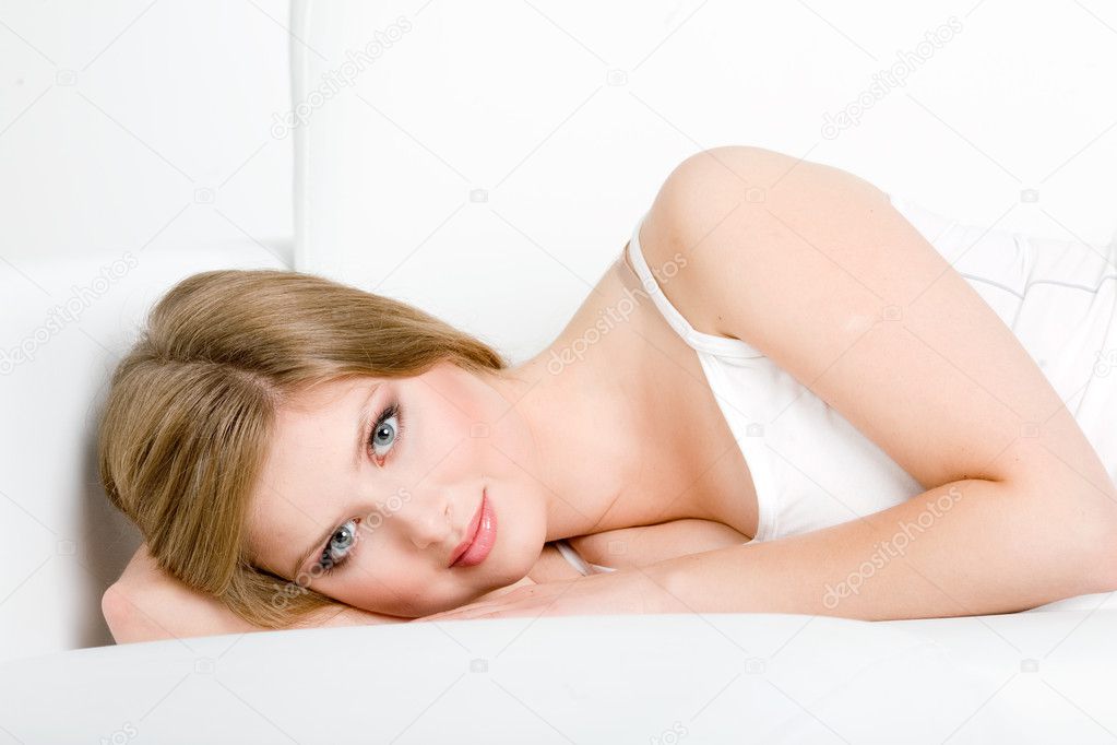 Woman relaxing on white couch