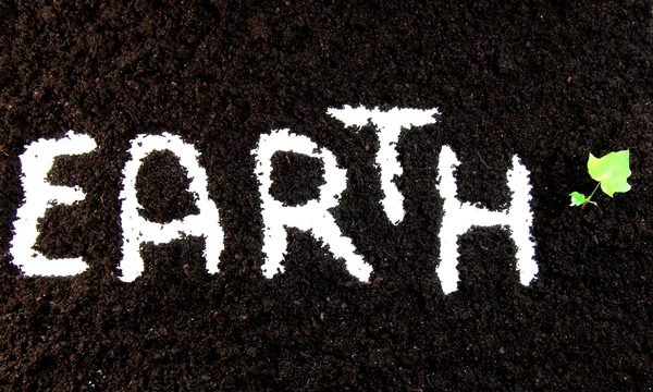 地球在土壤中的文本 — 图库照片