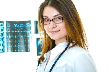 Woman doctor portrait with x-ray films on backgr clipart