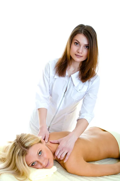 O massagista faz massagem à bela mulher Imagem De Stock