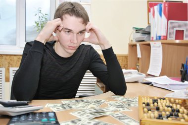 Young man thinking where to spend money clipart