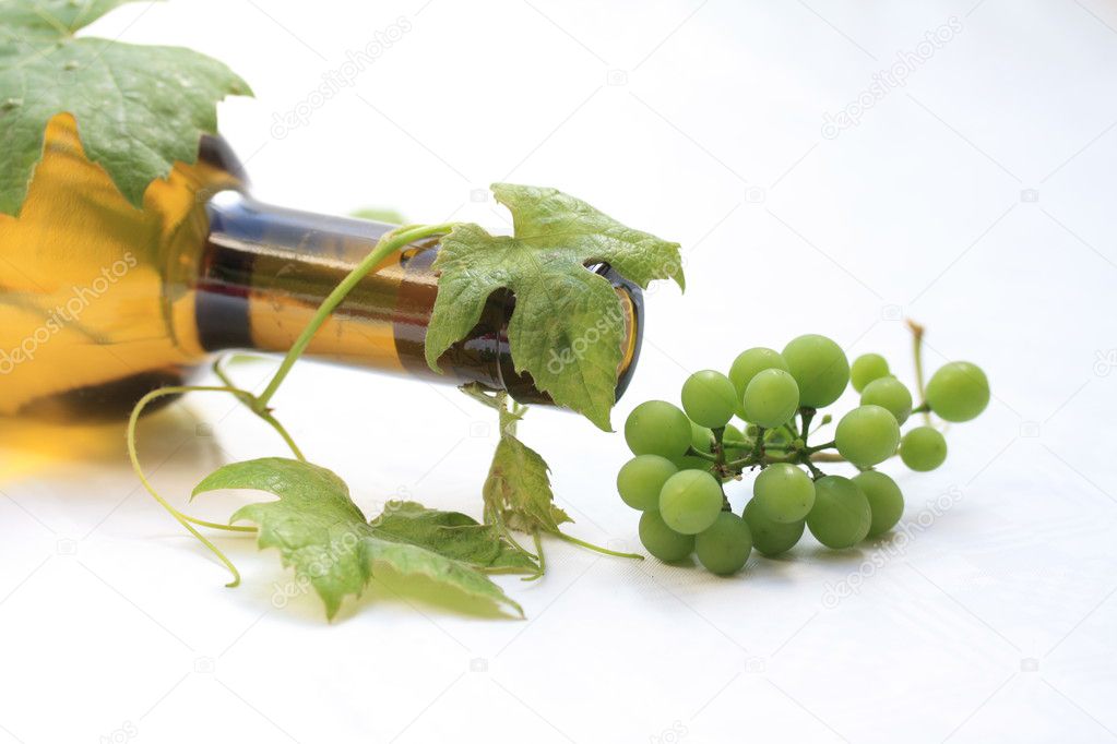 Bottle of white wine and grapes