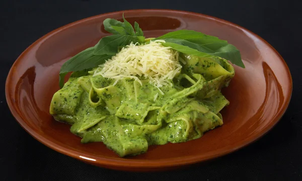 stock image Italian pasta with green herbal souse