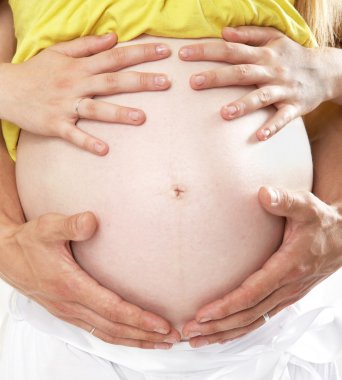 Pregnant woman contact with her belly. clipart