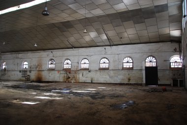 Abandoned empty warehouse. clipart