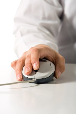 Hand holds computer mouse clipart