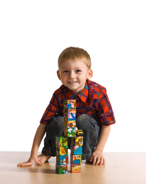 Child plays about cubes — Stock Photo, Image
