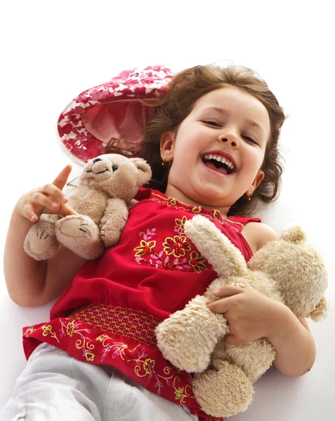Směje se holčička s hračkami — Stock fotografie