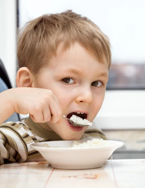 Pequeño niño come gachas — Foto de Stock