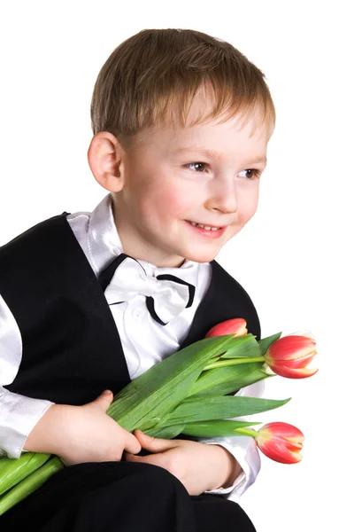 Niño pequeño con tulipanes — Foto de Stock