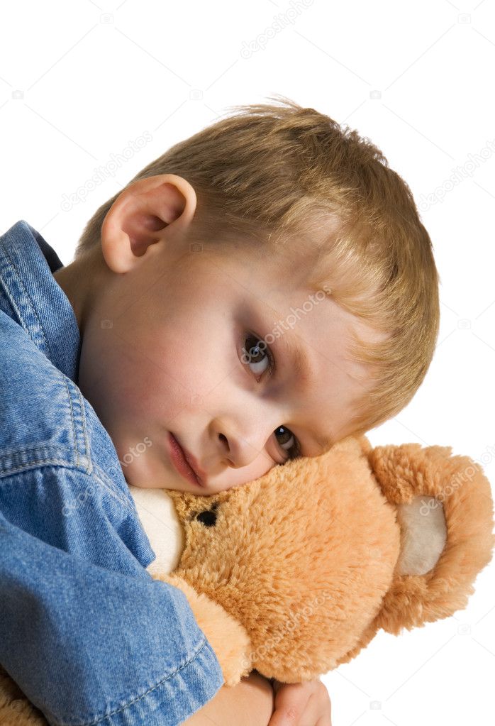 Sad kid embraces a teddy