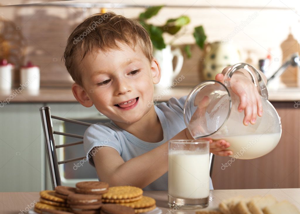 Healthy child pours milk from jug