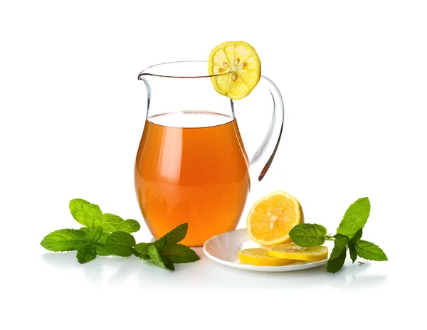 stock image Jug with cold tea and lemon slices