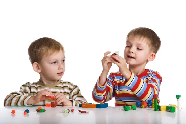 Boys mould toys from plasticine — Stock Photo, Image