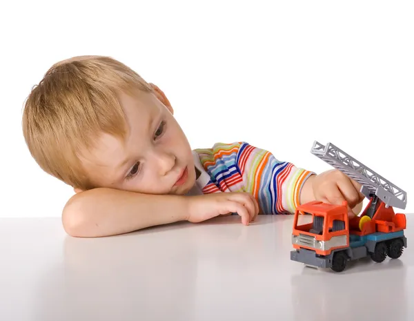 Cansado menino com brinquedos — Fotografia de Stock
