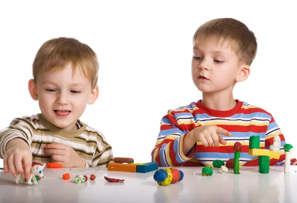 Boys mould toys from plasticine Stock Image