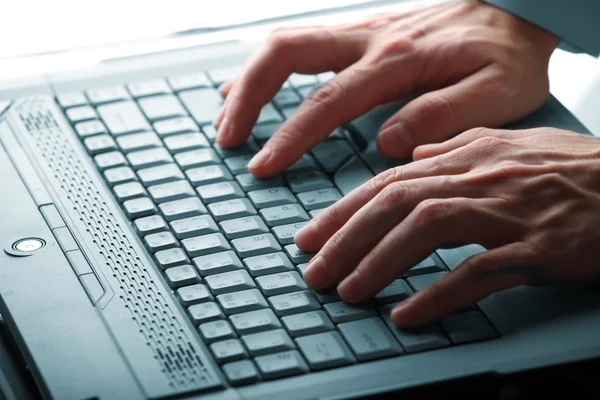 Male hands typing on a laptop — Stock Photo, Image