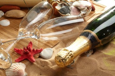 Champagne sparkling on a beach clipart