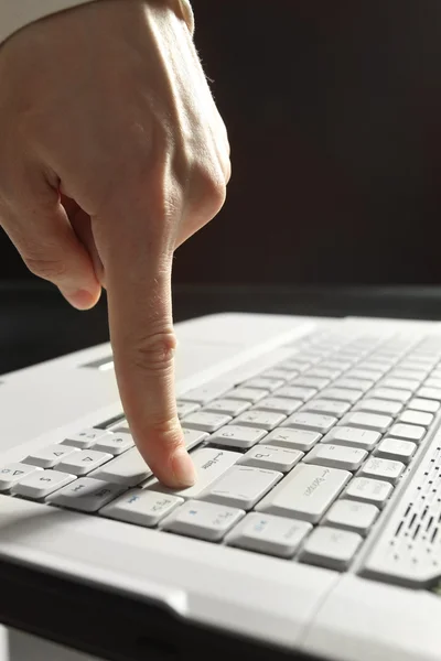 Close-up of hand touching computer keys — Stock Photo, Image