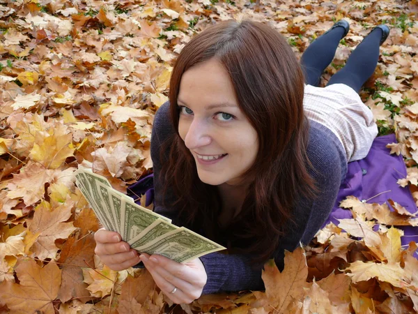 Young woman with dollars