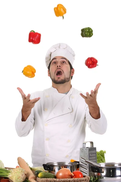 Chef malabarismo com pimentas — Fotografia de Stock