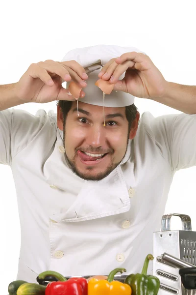 Funny chef cracking an egg — Stock Photo, Image