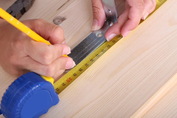 Wooden plank and measuring tape — Stock Photo, Image