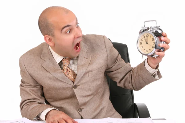 Businessman looking at clock alarm — Stock Photo, Image