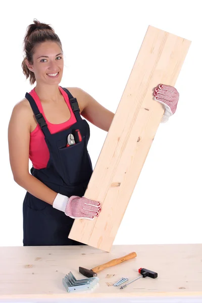 stock image Woman carpenter holding wooden plank