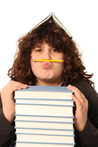 Мальчик с карандашом и книгами — стоковое фото