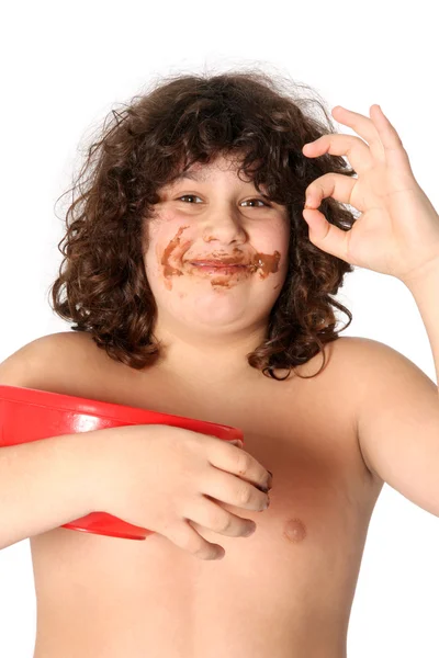 Dingy chico disfrutando de comer chocolate — Foto de Stock