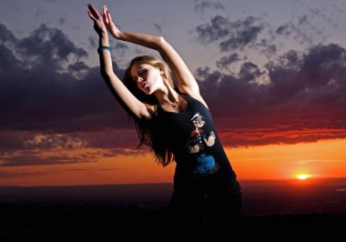 Beauty girl and sunset dances clipart