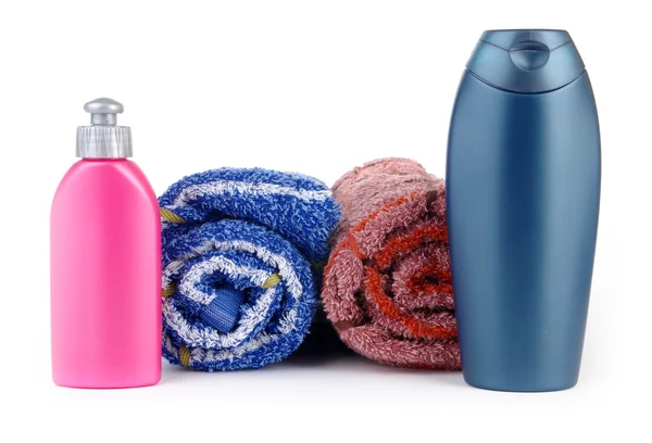 Cosmetic bottles with towel — Stock Photo, Image