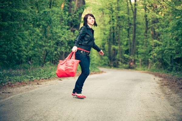 Beautiful young woman on the road — Stock Photo, Image